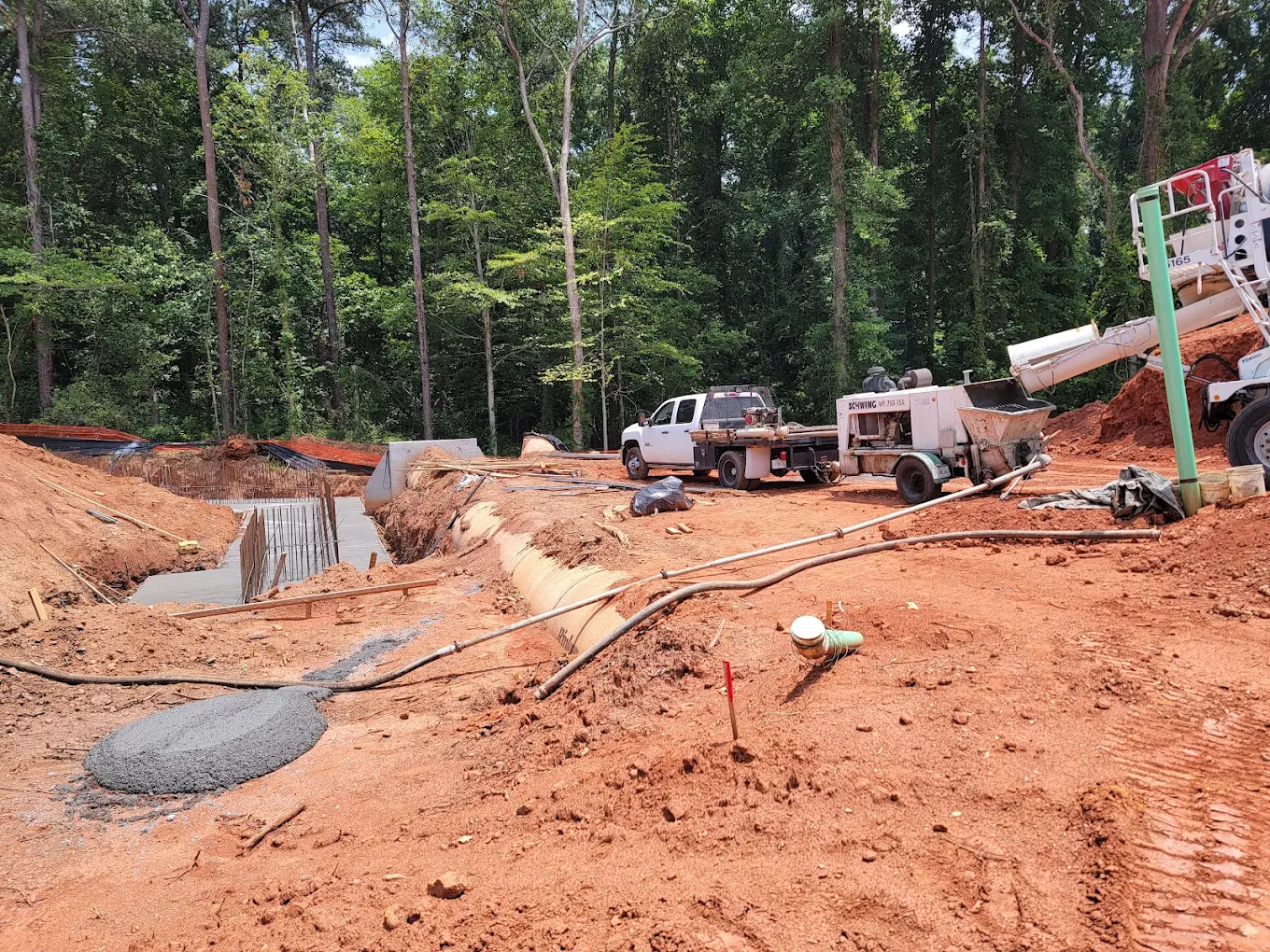 Workers operating concrete pump
